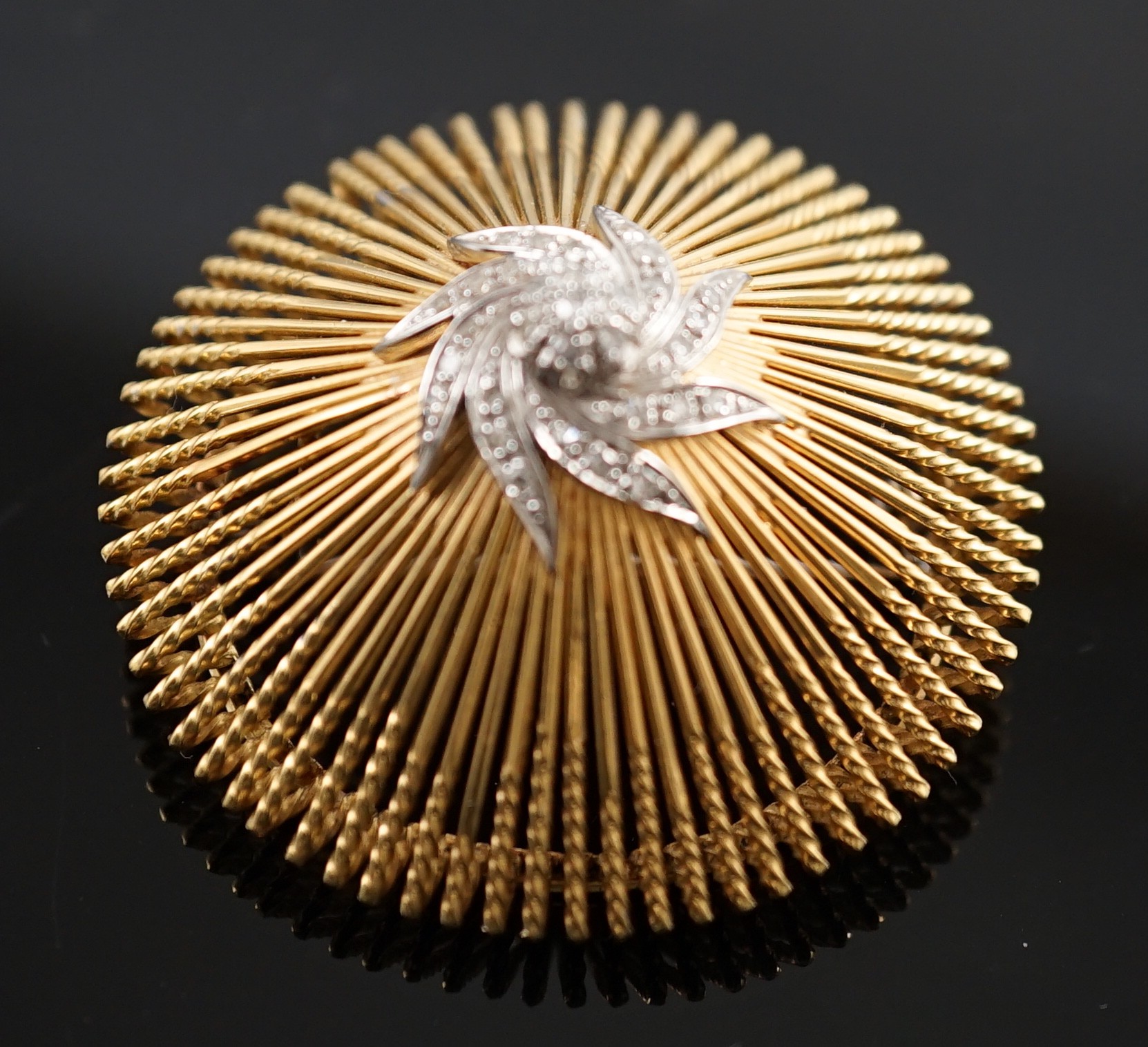 A modern stylish Italian pierced 18k and diamond chip set domed brooch